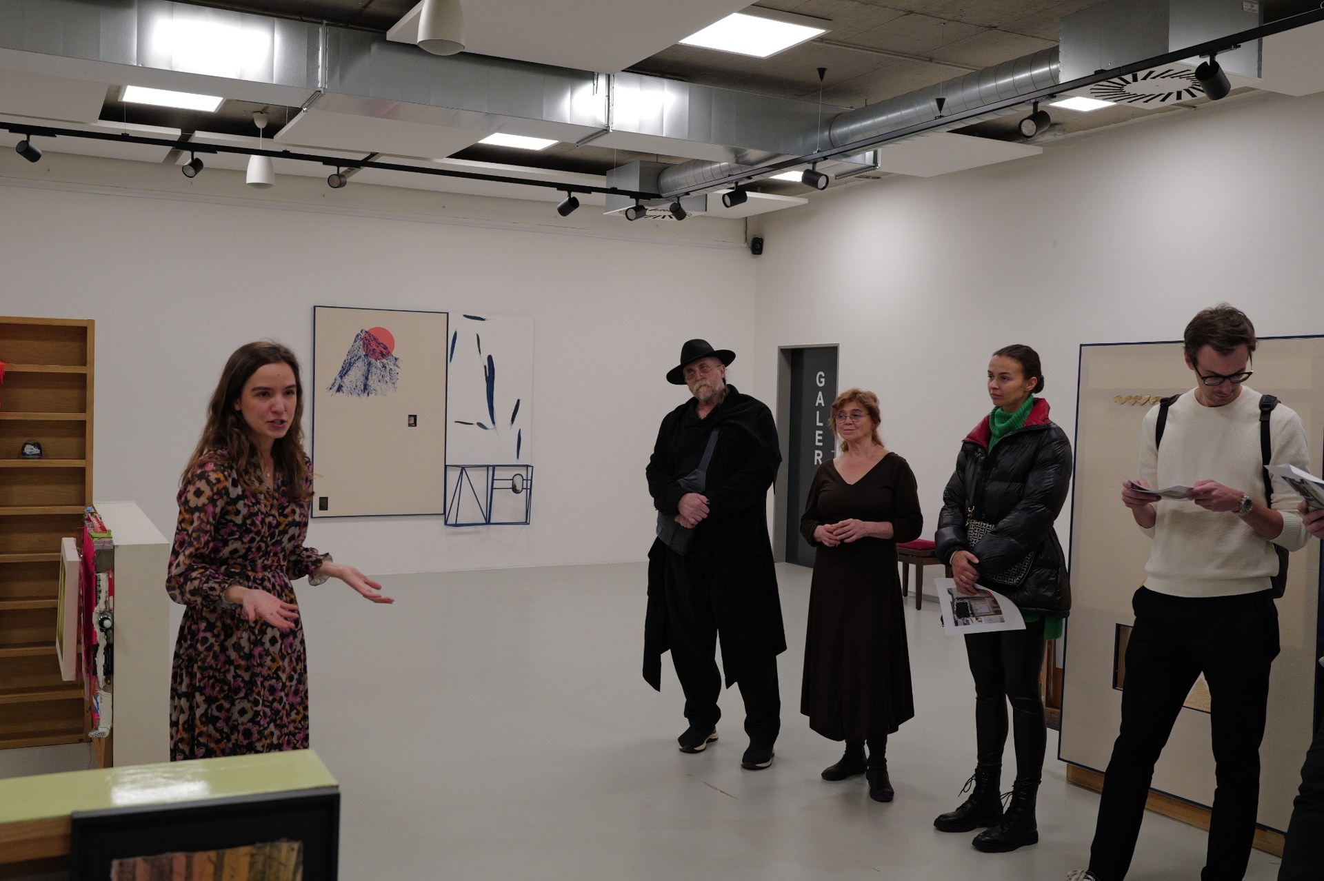Sofie discussing artworks with gallery visitors