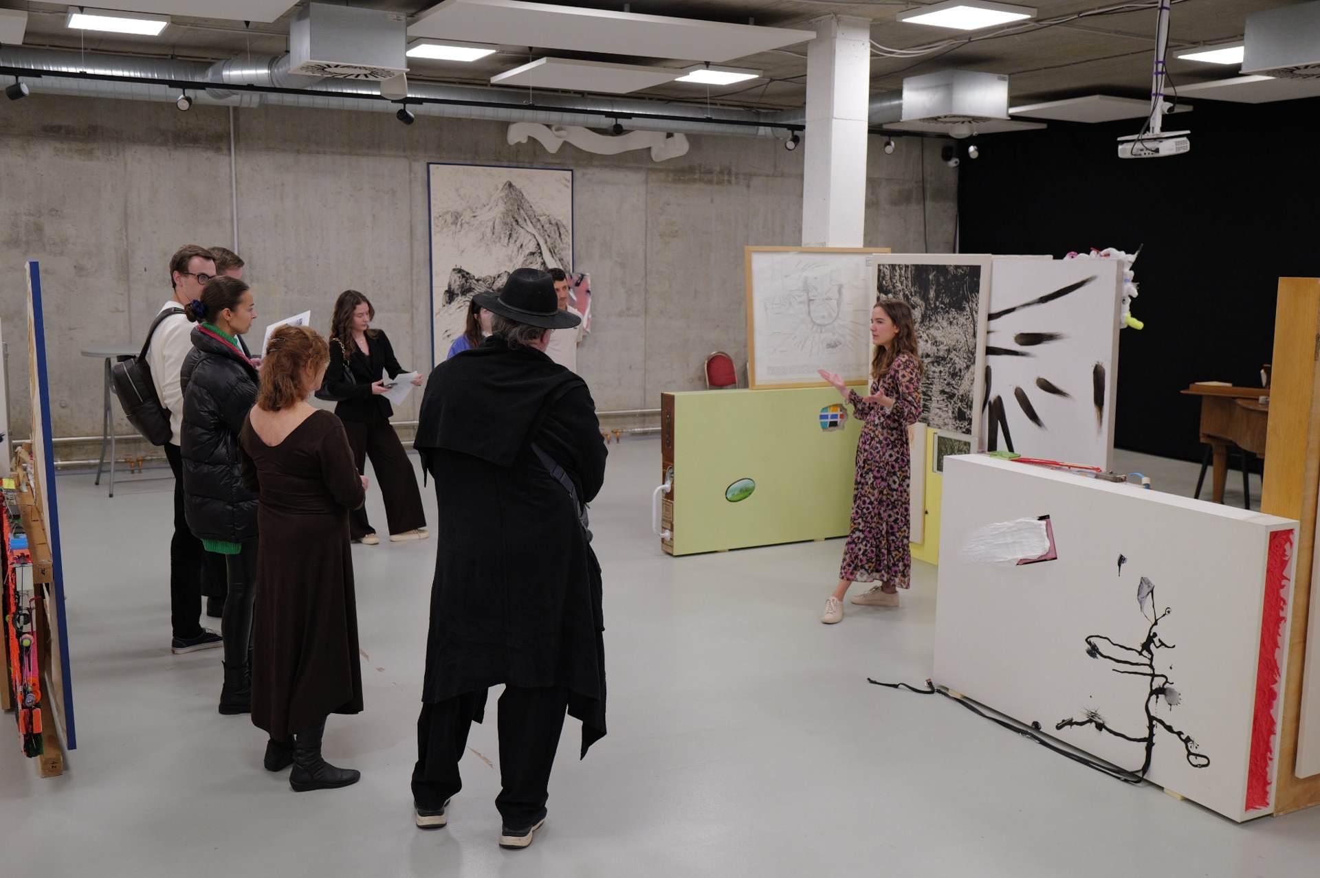 Sofie leading a conversation with visitors among contemporary artworks