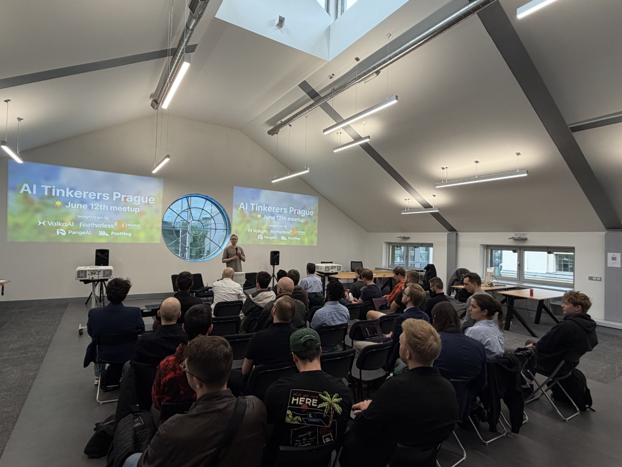Speaker and audience at an AI Tinkerers Prague meetup at Machine House